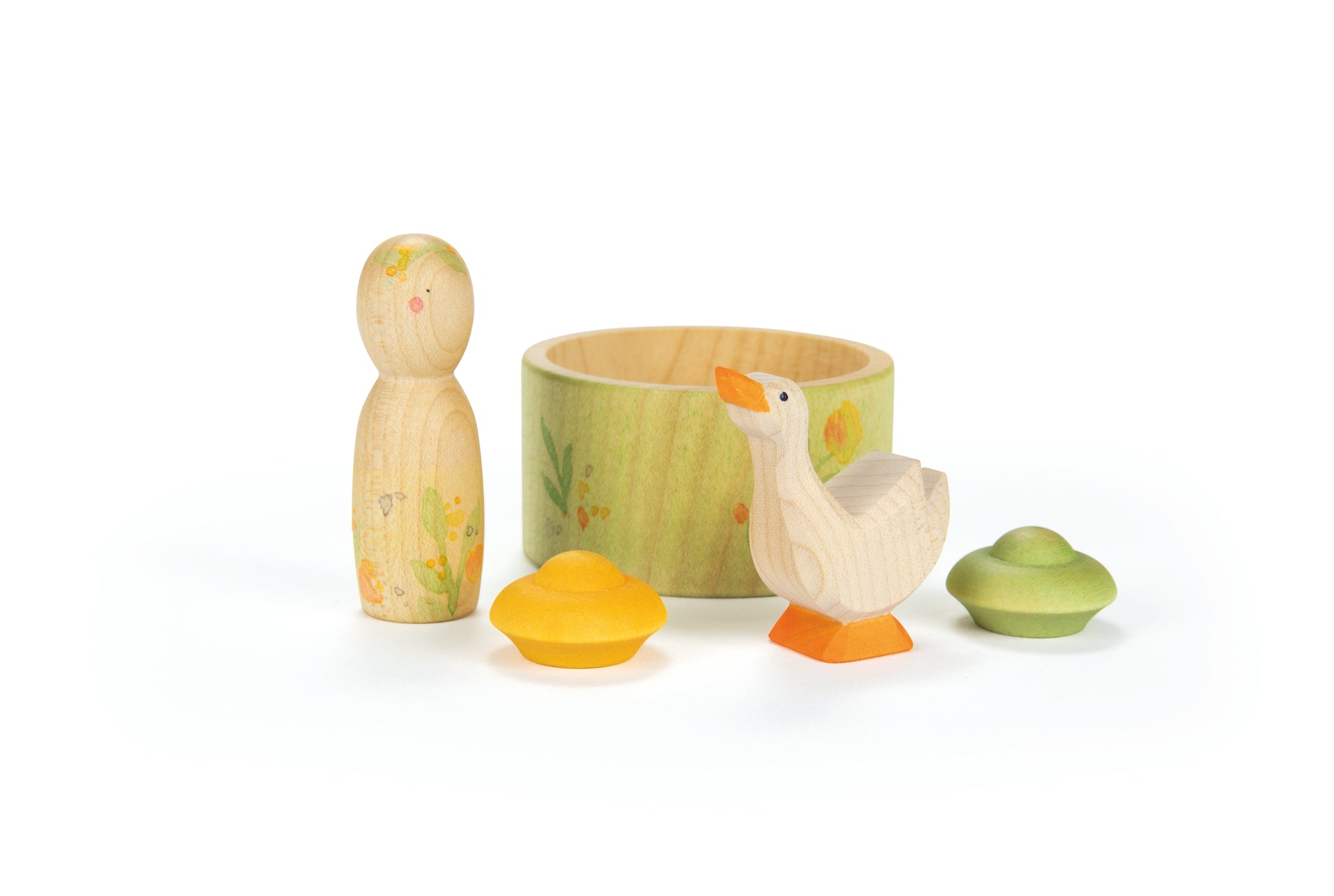 Set of wooden duck toys with a green container on a white background