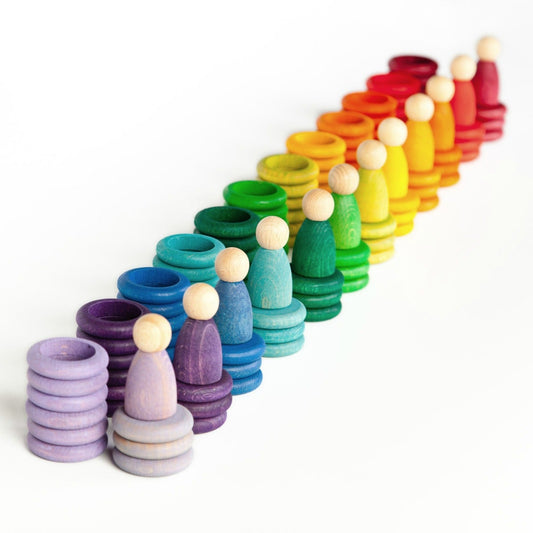Grapats Nins Carla.  An array of colorful wooden toys arranged in a rainbow pattern on a white background