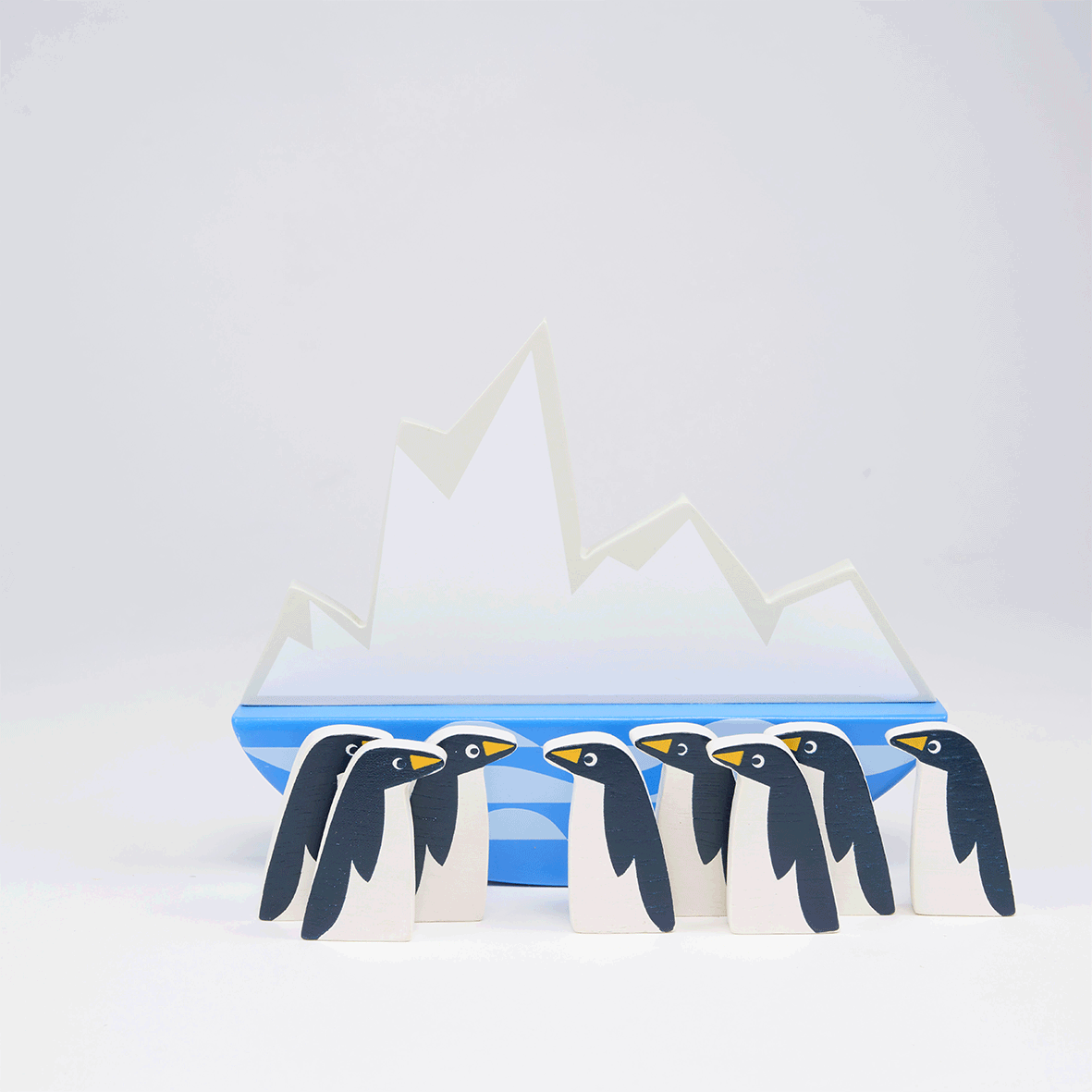 Video showing wooden toy penguin stacking game. Penguins are balanced on a rocking iceberg platform.