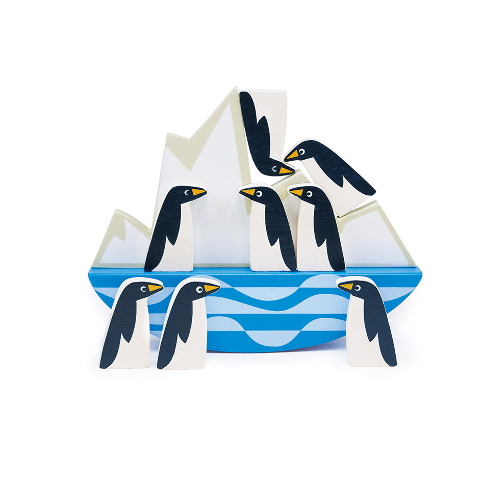 Wooden toy penguin stacking game. Balance the penguins on the tilting iceberg.