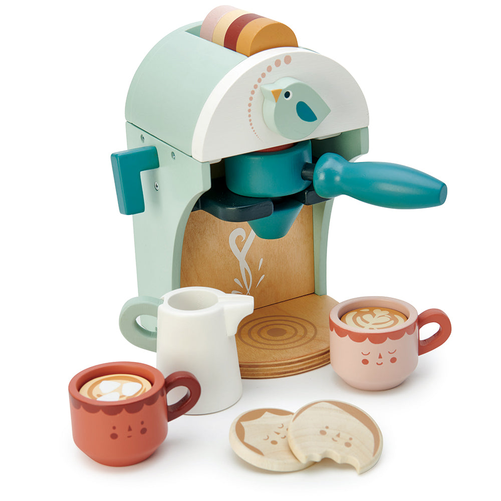 Wooden toy cappuccino maker in shades of green with a milk jug, two cups and two biscuits.