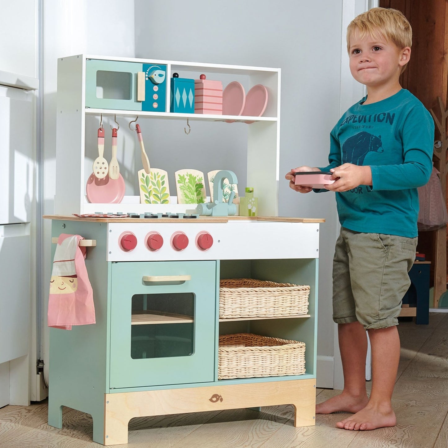 Tender Leaf Toys Kitchen Range front view with child showing kitchen accessories