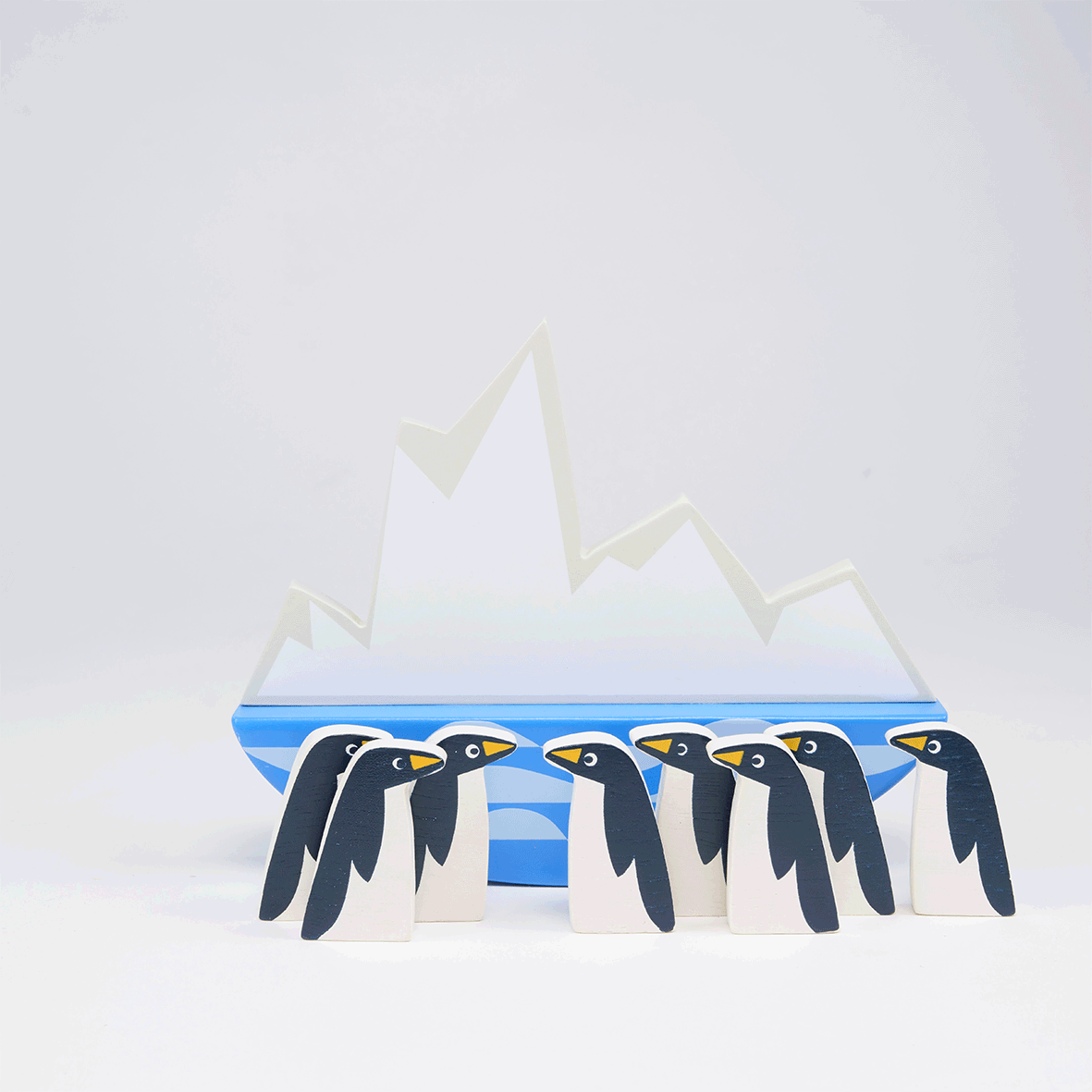 Video showing wooden toy penguin stacking game.  Penguins are balanced on a rocking iceberg platform.