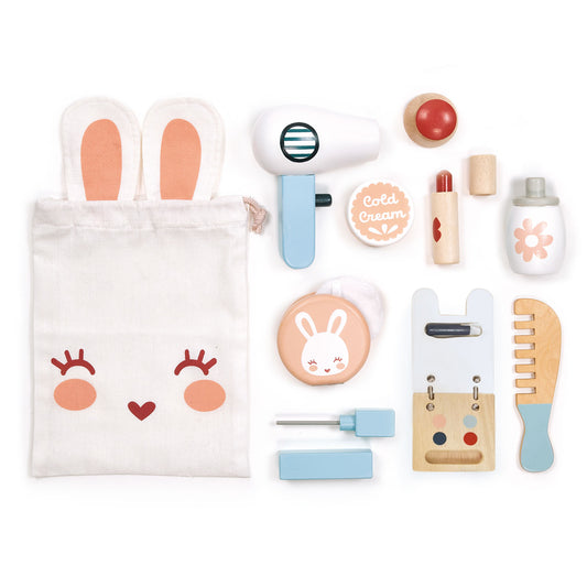 Wooden toy bunny themed make up set laid out.  Set includes a fabric bag, lipstick, nail varnish, cream pot, comb, hair dryer, mascara stick, eye shadow pallet, perfume bottle and a powder puff with mirror.