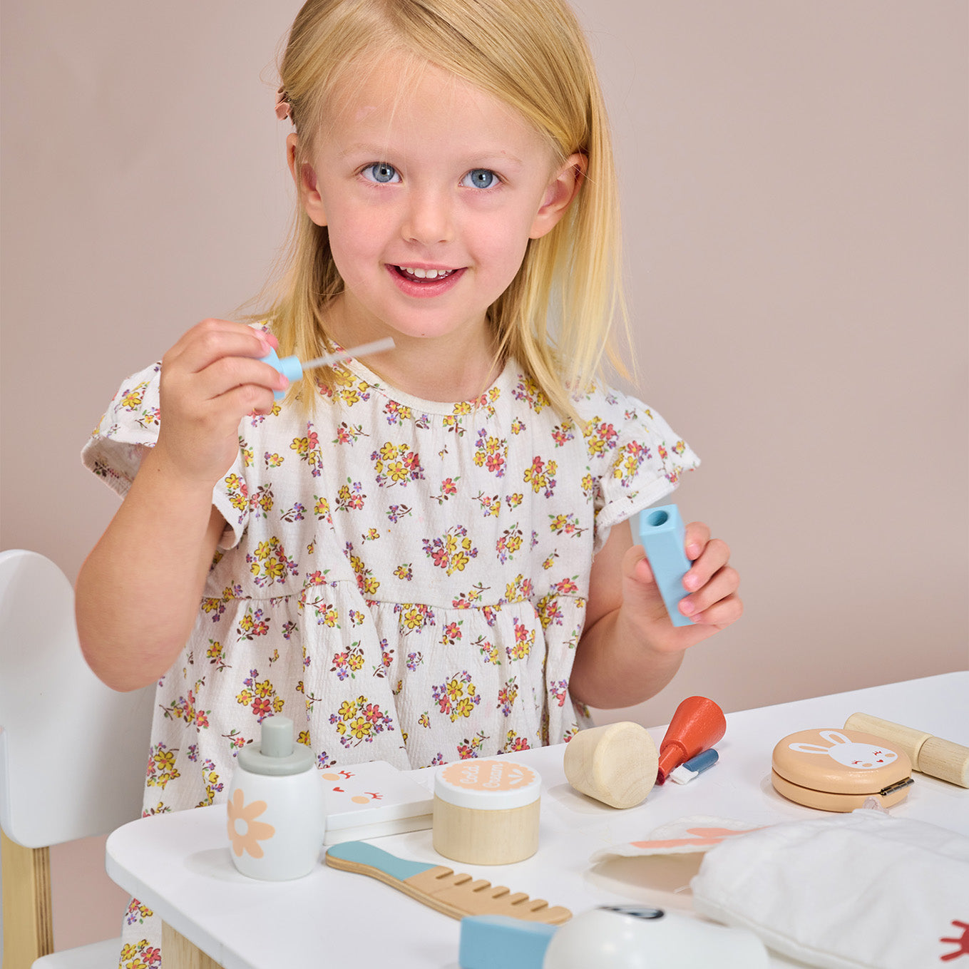 Child playing with wooden toy bunny themed make up set