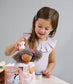 Child playing with wooden pretend play hair salon with doll.