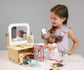 Child playing with wooden pretend play hair salon.  Drying dolls hair with wooden hairdryer.
