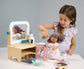 Child playing with wooden pretend play hair salon.  Cutting dolls hair with wooden scissors.