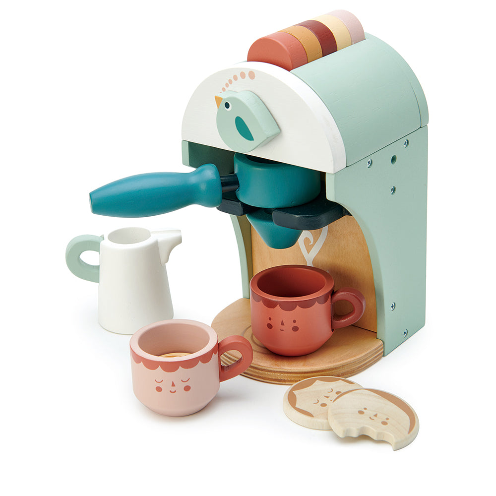 Wooden toy cappuccino maker with milk jug, two cups and two biscuits.