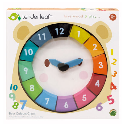 Box containing wooden bear clock with removable numbers and moving hands.