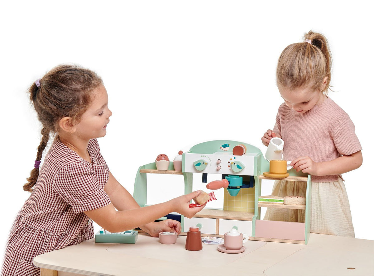 Children playing with wooden toy cafe playset