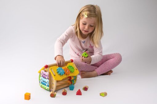 Interactive wooden activity house for toddler play - Froglet Toys
